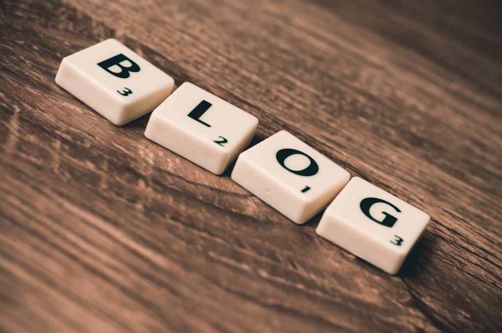 pexels photo 262508 Scrabble tiles spelling 'BLOG' on a wooden background, symbolizing creativity and writing.