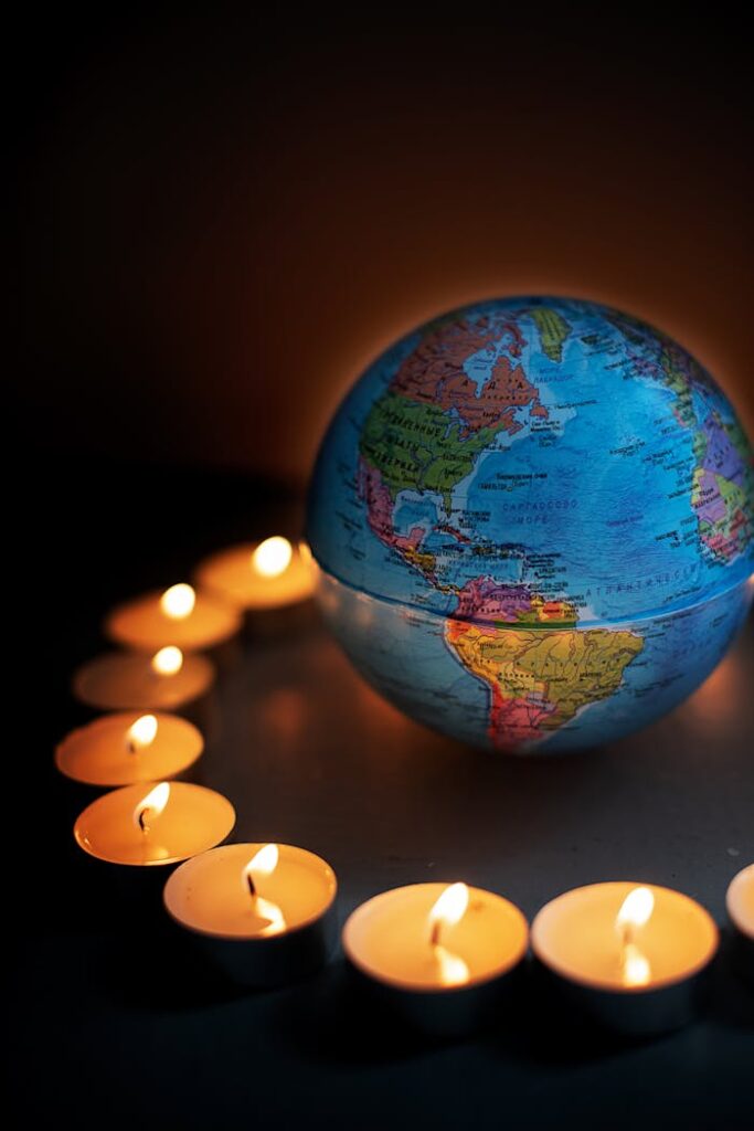 pexels photo 8543546 A globe encircled by lit candles, symbolizing global unity and peace.